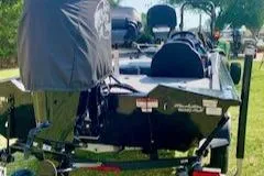 Slide: The Image of 2023 Tracker Pro Team 175 TXW boat on trailer, parked on grass. - 5