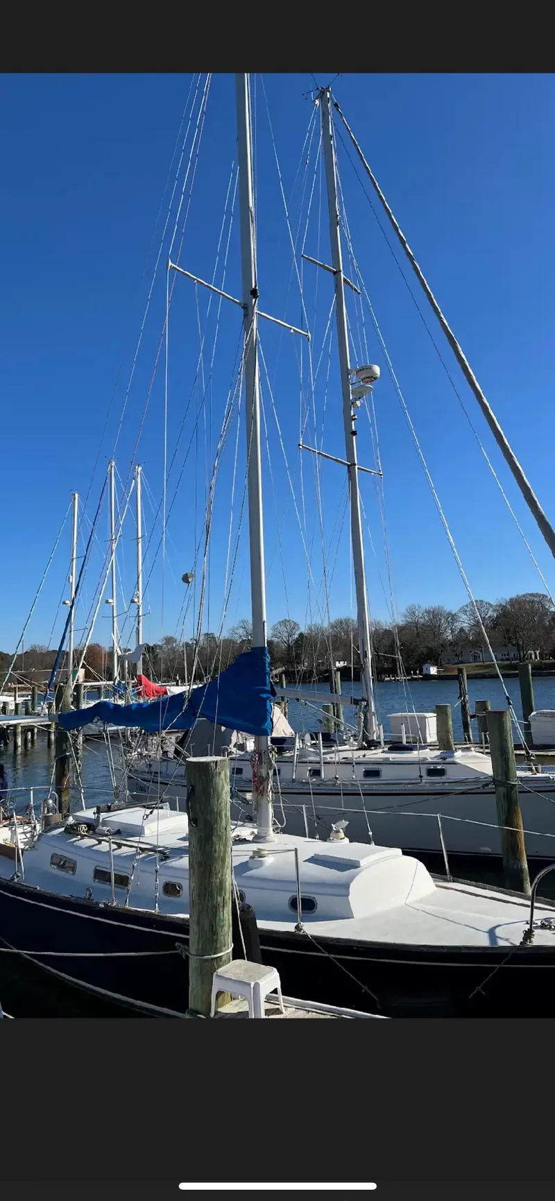Slide: The Image of 1975 Bristol 34 sailboat docked at a marina under a clear blue sky. - 2
