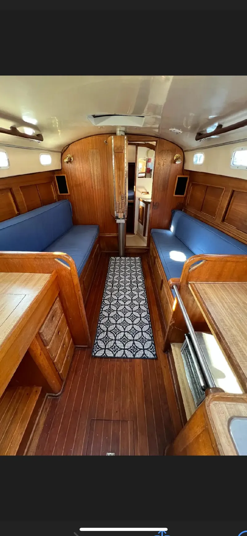 Slide: The Image of 1975 Bristol 34 sailboat docked, featuring stern view and water reflection. - 8