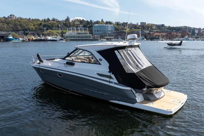 Slide: The Image of 2018 Regal 35 Sport Coupe on scenic waterfront with city skyline backdrop. - 11