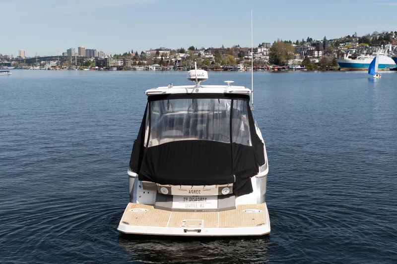 Slide: The Image of 2018 Regal 35 Sport Coupe on calm water with cityscape background. - 13