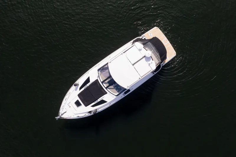 Slide: The Image of Overhead view of a 2018 Regal 35 Sport Coupe yacht on dark water. - 15