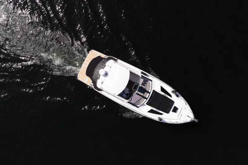 Slide: The Image of Aerial view of 2018 Regal 35 Sport Coupe cruising on dark water. - 17