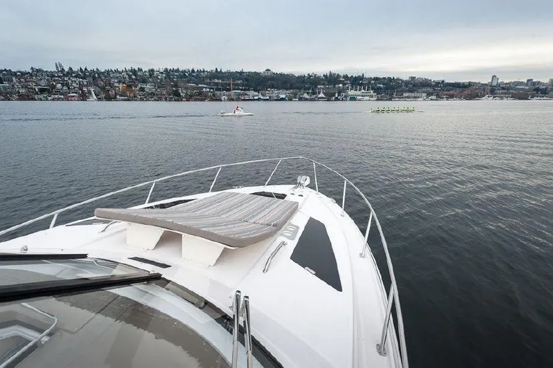 Slide: The Image of 2018 Regal 35 Sport Coupe cruising on a serene lake with cityscape background. - 20