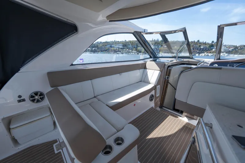 Slide: The Image of 2018 Regal 35 Sport Coupe interior with beige seating and panoramic windows. - 24