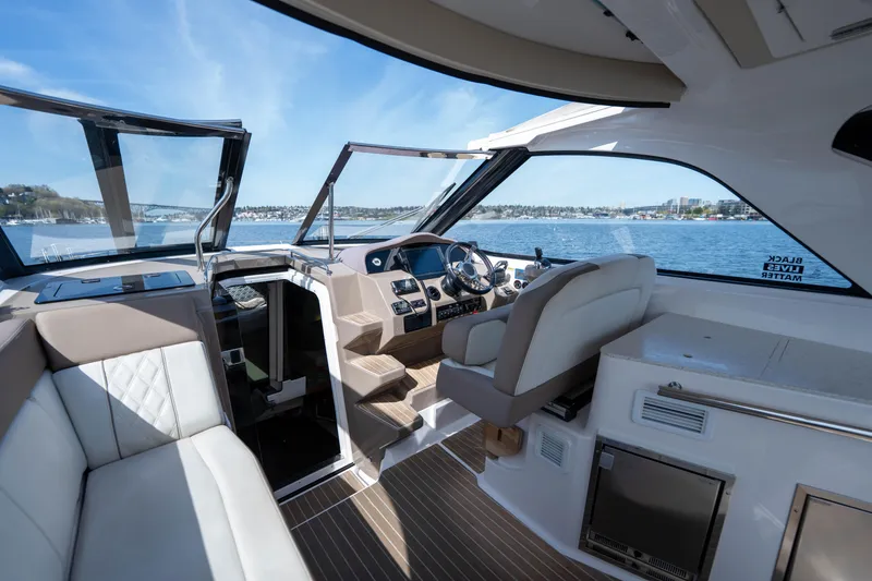 Slide: The Image of Interior of 2018 Regal 35 Sport Coupe yacht with luxurious seating and modern dashboard. - 25