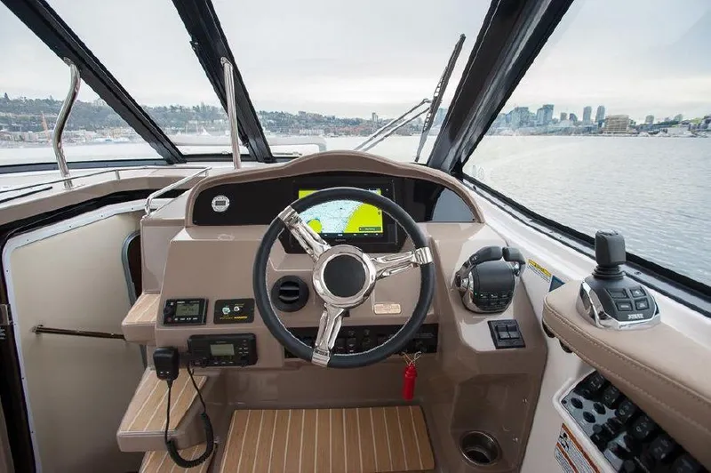 Slide: The Image of 2018 Regal 35 Sport Coupe helm with modern controls and city skyline view. - 26