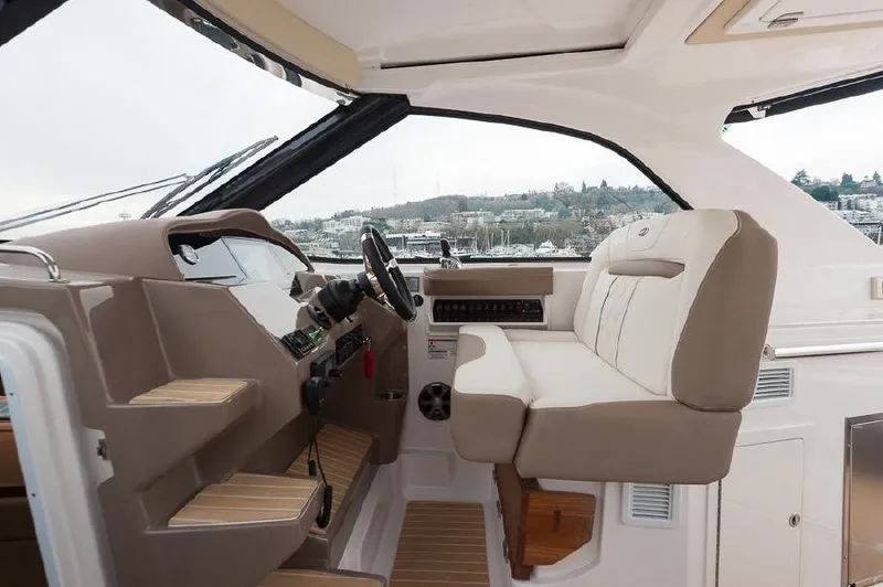 Slide: The Image of 2018 Regal 35 Sport Coupe interior with beige seating and modern dashboard. - 28