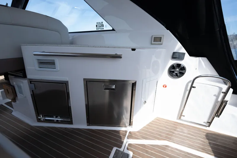 Slide: The Image of 2018 Regal 35 Sport Coupe interior with kitchenette and modern amenities. - 29