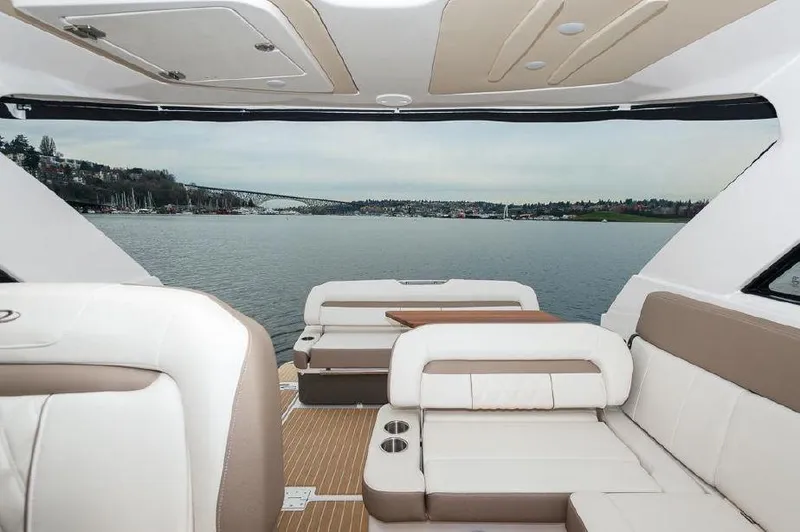 Slide: The Image of 2018 Regal 35 Sport Coupe interior with lake view, featuring luxurious seating and modern design. - 32