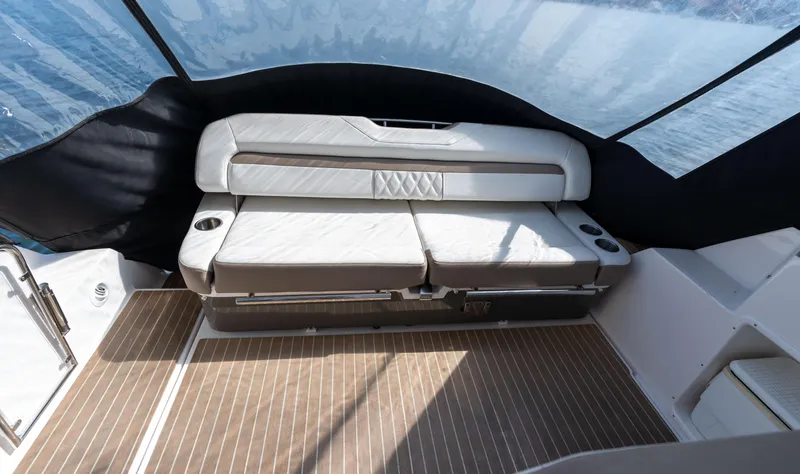 Slide: The Image of 2018 Regal 35 Sport Coupe interior with cushioned seating and wood-patterned flooring. - 34