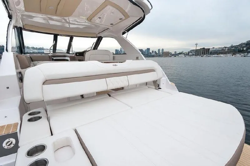 Slide: The Image of 2018 Regal 35 Sport Coupe yacht with spacious deck overlooking city skyline. - 37