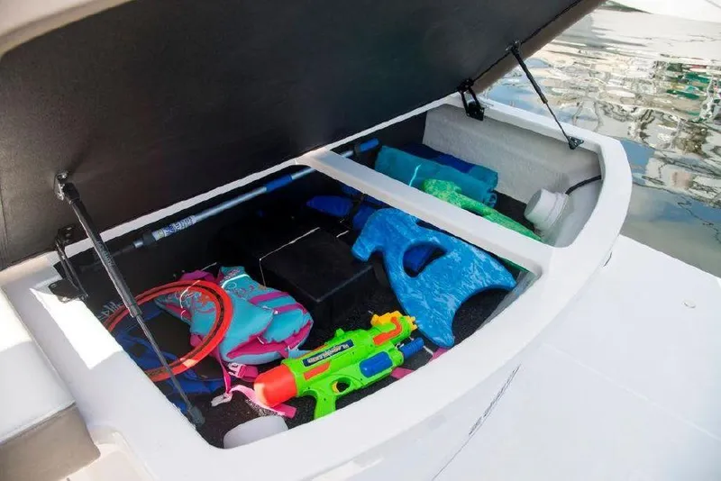 Slide: The Image of Storage compartment of 2018 Regal 35 Sport Coupe filled with colorful water toys. - 38