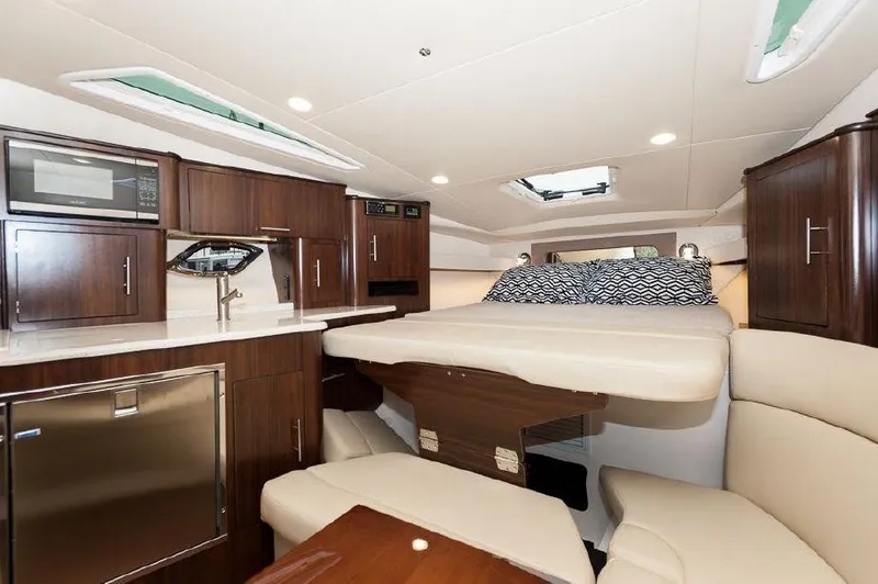 Slide: The Image of Interior of 2018 Regal 35 Sport Coupe with modern kitchen and cozy sleeping area. - 43