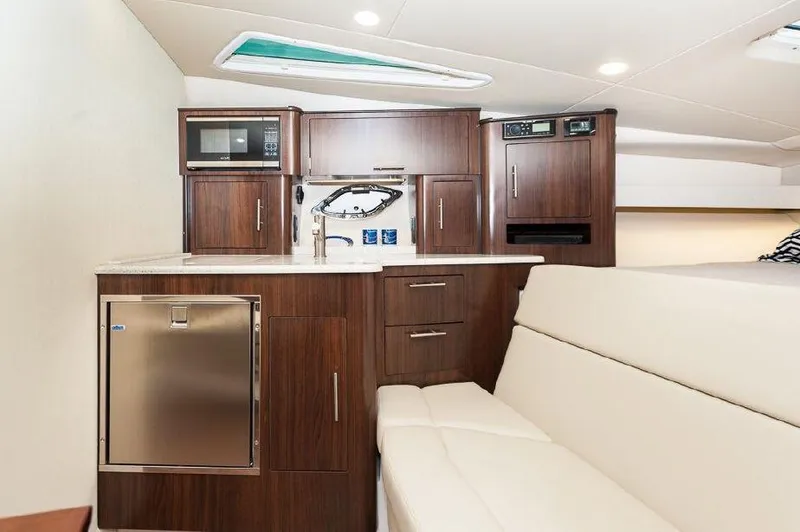 Slide: The Image of 2018 Regal 35 Sport Coupe interior with modern kitchenette and seating area. - 44