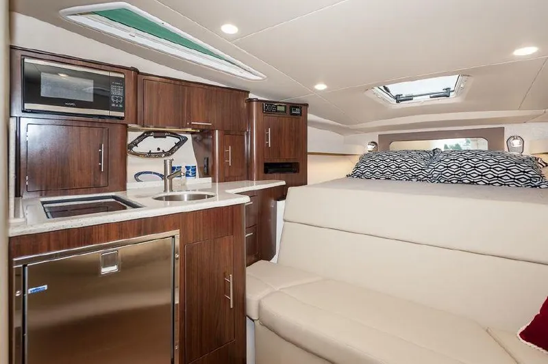 Slide: The Image of Luxurious interior of 2018 Regal 35 Sport Coupe with kitchenette and cozy seating area. - 45