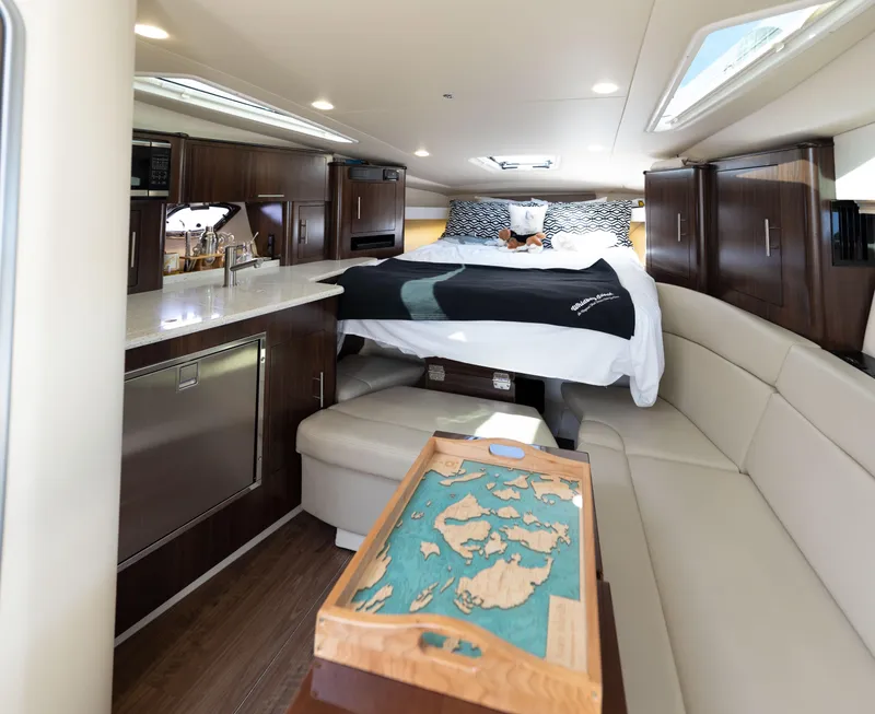 Slide: The Image of Luxurious interior of a 2018 Regal 35 Sport Coupe yacht with bed and kitchenette. - 46