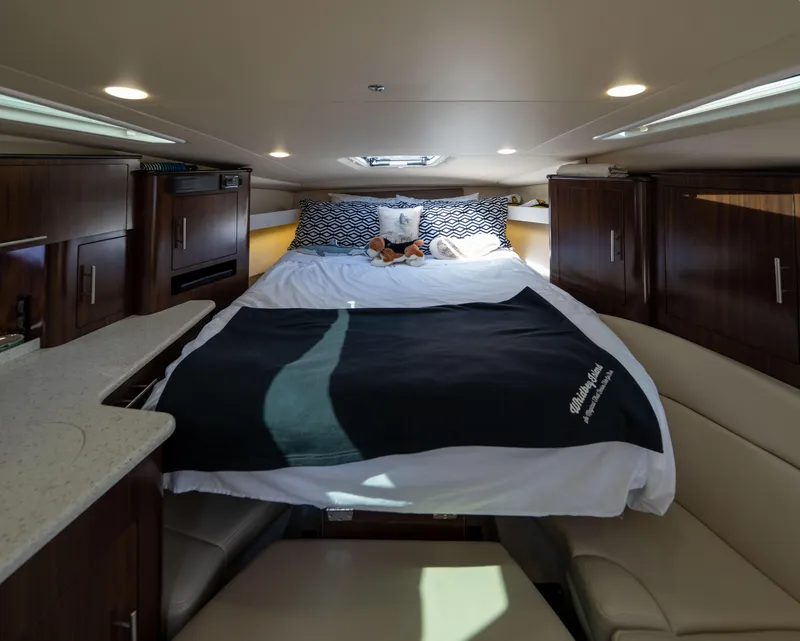 Slide: The Image of Interior of 2018 Regal 35 Sport Coupe with cozy bed and wooden cabinetry. - 47