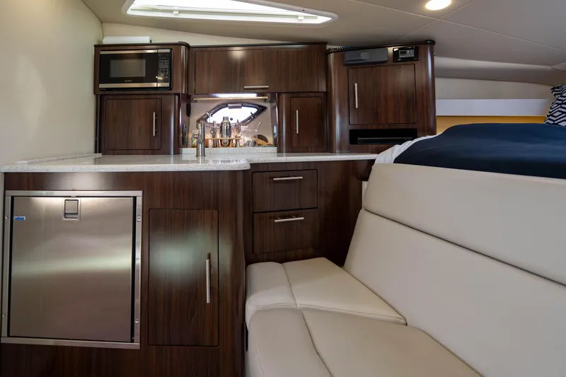 Slide: The Image of 2018 Regal 35 Sport Coupe interior with modern kitchen and seating area. - 48