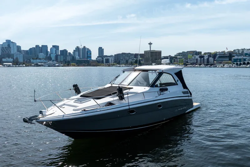 Slide: The Image of 2018 Regal 35 Sport Coupe yacht on water with city skyline in background. - 8