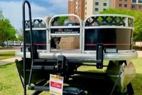 Slide: The Image of 2019 Sun Tracker BASS BUGGY 18 pontoon boat displayed outdoors with price tag. - 5