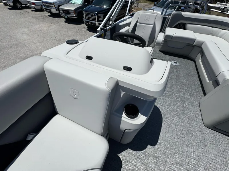 Slide: The Image of 2025 Sweetwater 2286 C boat interior with gray seating and steering console. - 11