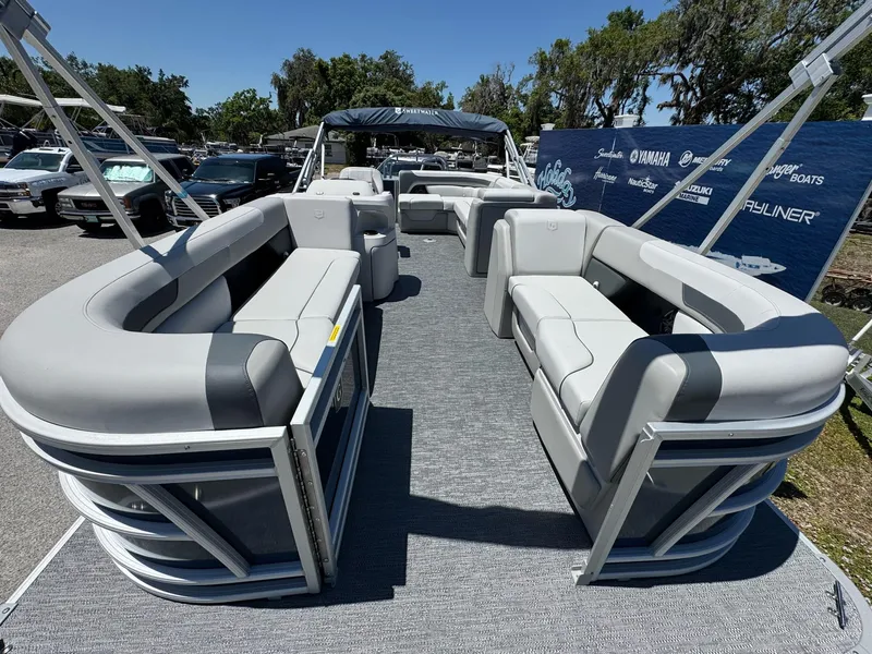 Slide: The Image of 2025 Sweetwater 2286 C pontoon boat with spacious seating, displayed outdoors. - 3