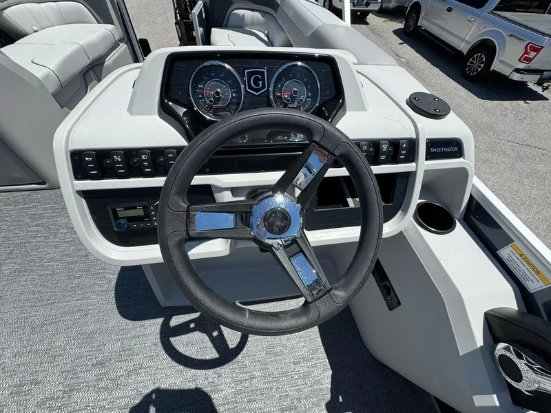 Slide: The Image of 2025 Sweetwater 2286 C boat dashboard with steering wheel and instrument panel. - 4