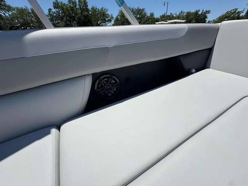 Slide: The Image of 2025 Sweetwater 2286 C boat interior with cushioned seating and speaker detail. - 5
