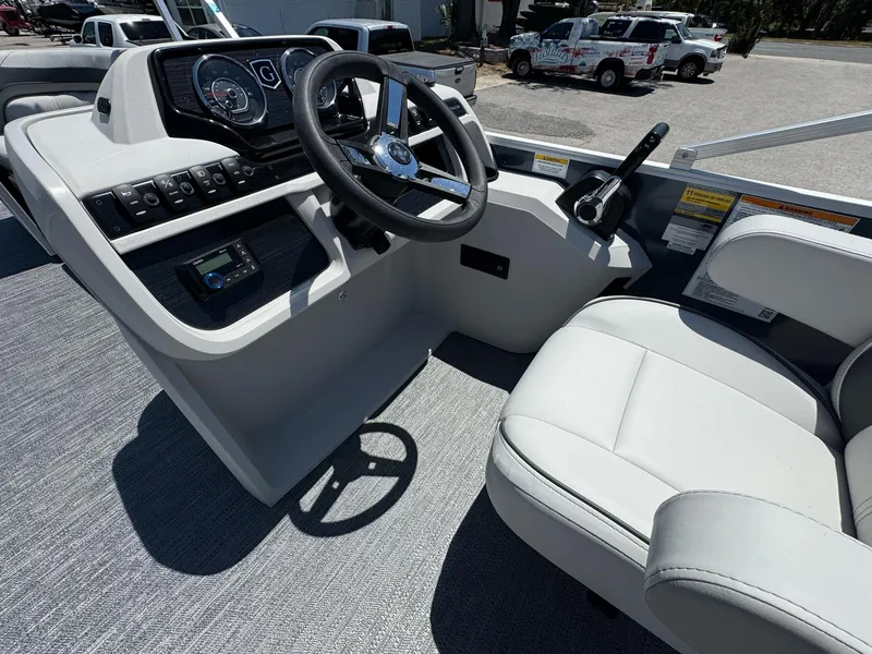 Slide: The Image of 2025 Sweetwater 2286 C boat cockpit with steering wheel and control panel. - 6