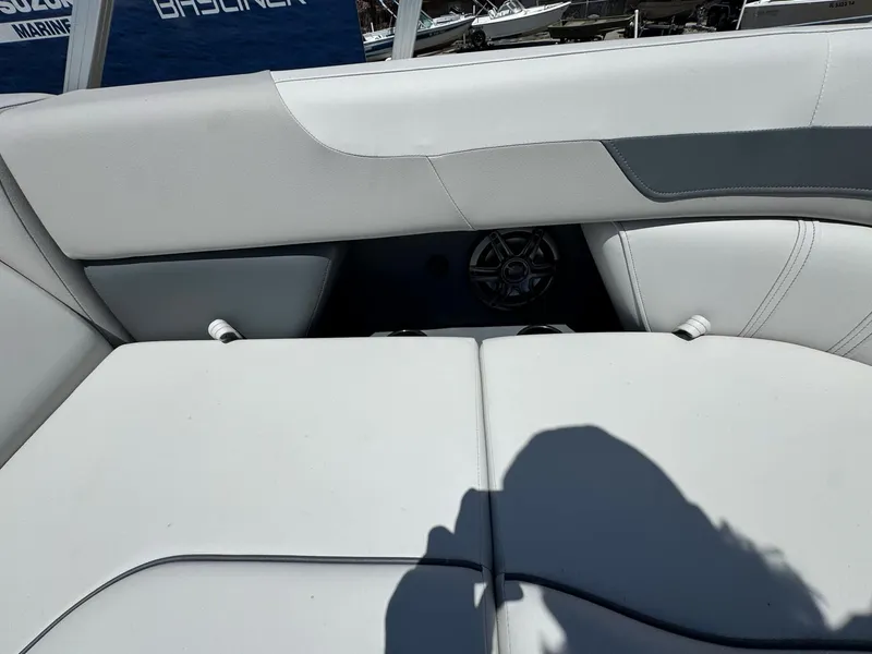 Slide: The Image of 2025 Sweetwater 2286 C boat interior with white cushioned seating and speaker. - 7