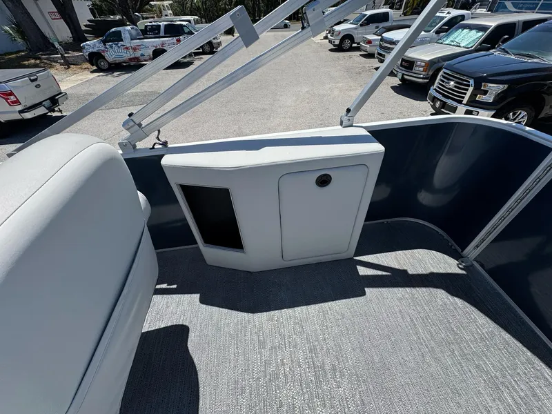 Slide: The Image of 2025 Sweetwater 2286 C boat interior with seating and storage compartment. - 8