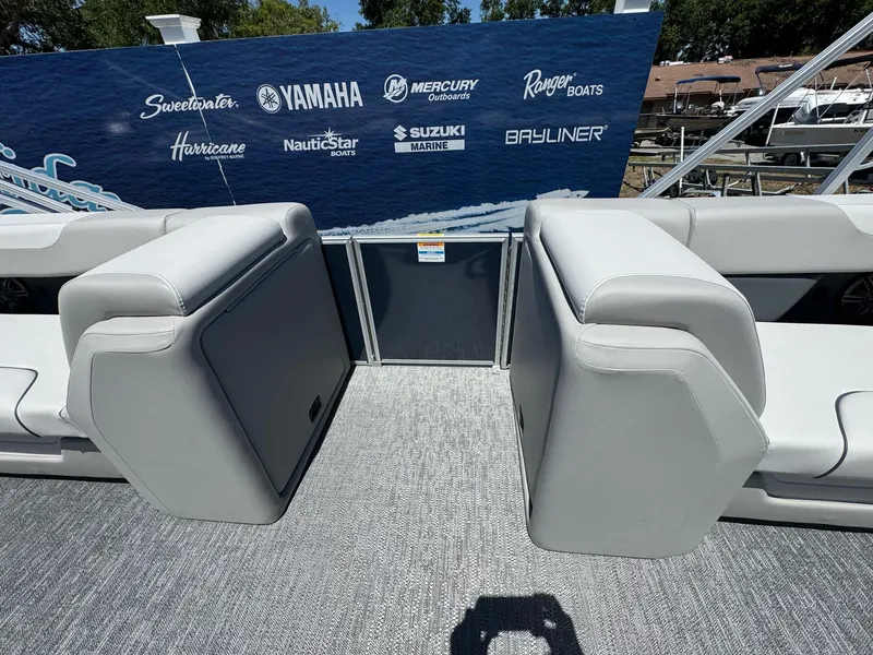 Slide: The Image of 2025 Sweetwater 2286 C boat interior with gray seating and brand logos in the background. - 9