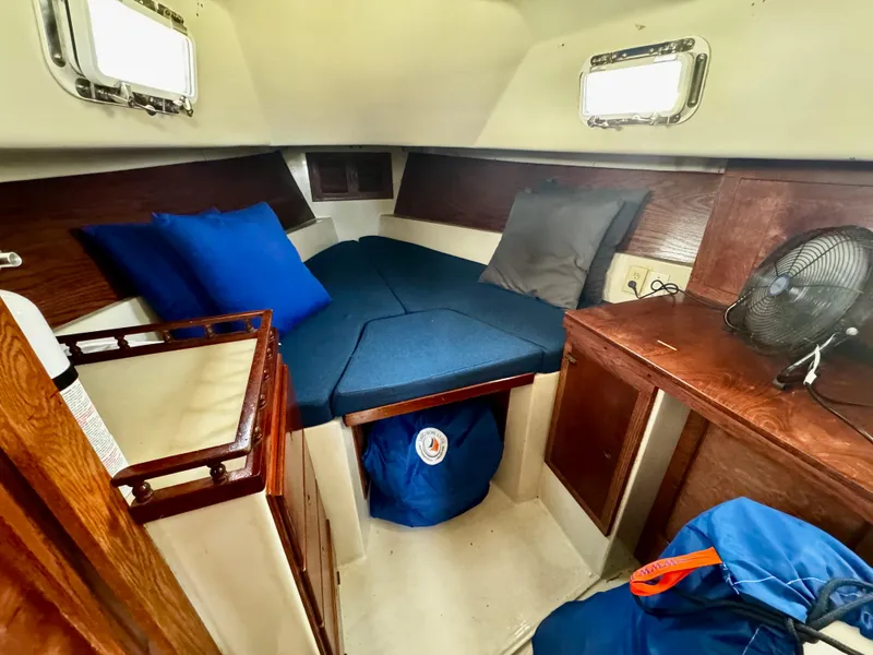 Slide: The Image of Cozy cabin interior of a 1974 Irwin 37 sailboat with blue cushions and wooden accents. - 15