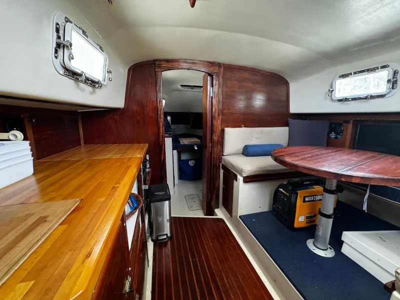 Slide: The Image of 1974 Irwin 37 sailboat interior with wooden finishes and seating area. - 16