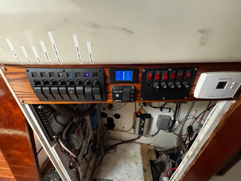Slide: The Image of Electrical control panel on a 1974 Irwin 37 sailboat, featuring switches and wiring. - 19