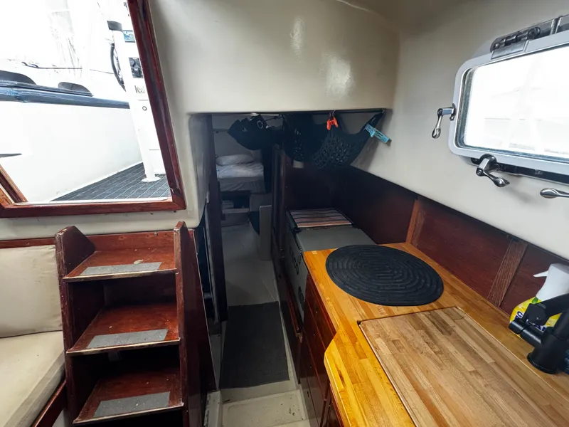 Slide: The Image of Interior of a 1974 Irwin 37 sailboat, featuring wooden cabinetry and compact design. - 20