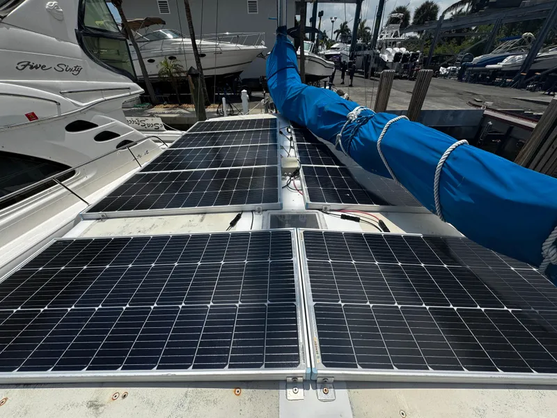 Slide: The Image of Solar panels on a 1974 Irwin 37 sailboat deck, docked at a marina. - 24