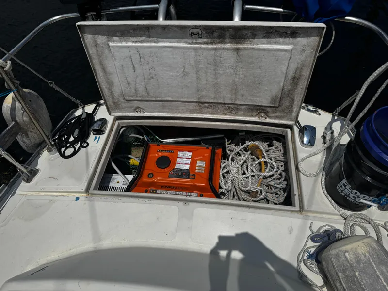 Slide: The Image of Open storage compartment on a 1974 Irwin 37 sailboat, containing ropes and equipment. - 25