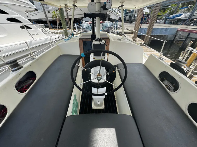 Slide: The Image of Cockpit of a 1974 Irwin 37 sailboat with steering wheel and seating. - 27