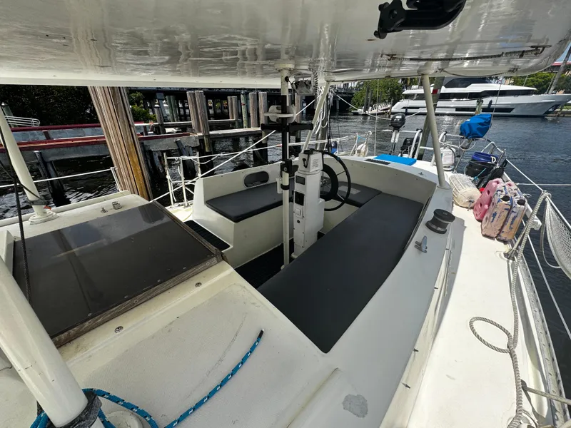 Slide: The Image of 1974 Irwin 37 sailboat cockpit with steering wheel, docked at marina. - 29