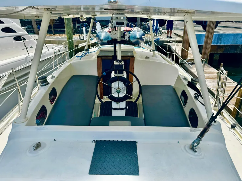 Slide: The Image of 1974 Irwin 37 sailboat cockpit with dual seating and steering wheel. - 35