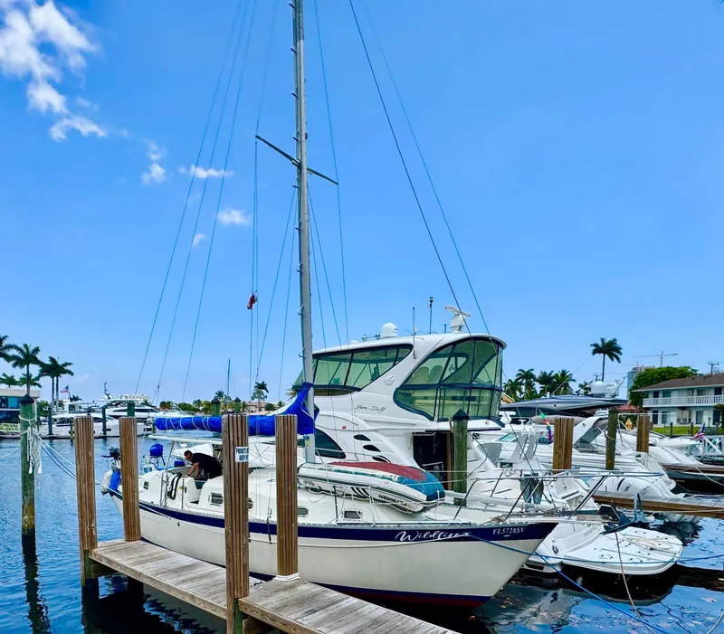 Slide: The Image of 1974 Irwin 37 sailboat docked at marina under clear blue sky. - 36