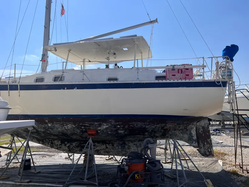 Slide: The Image of 1974 Irwin 37 sailboat on stands, undergoing maintenance in a boatyard. - 40