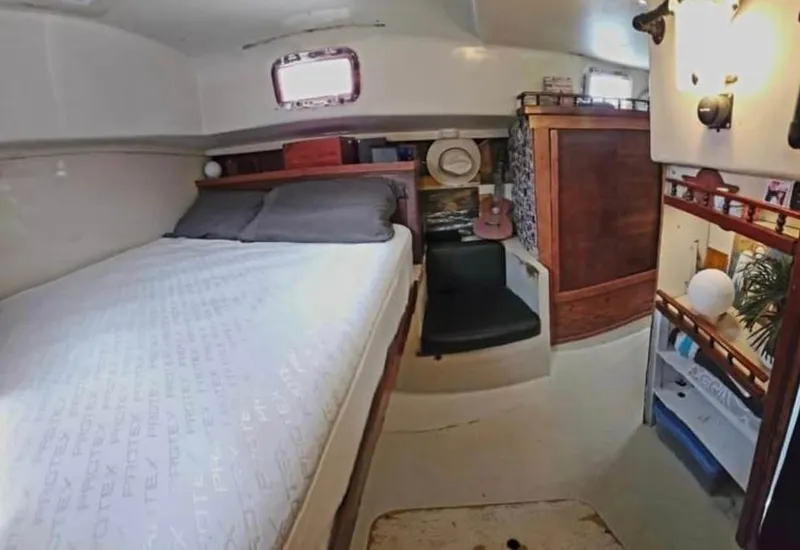 Slide: The Image of Cozy cabin interior of a 1974 Irwin 37 sailboat with bed and storage. - 8