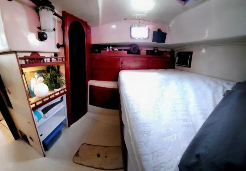 Slide: The Image of Cozy cabin interior of a 1974 Irwin 37 sailboat with bed and storage. - 9