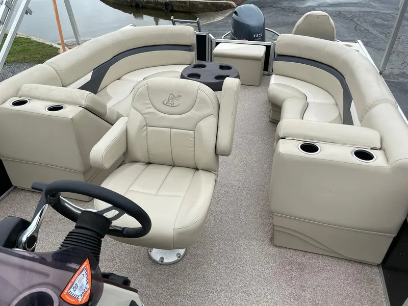 Slide: The Image of 2017 Misty Harbor 245 Adventure CC boat with beige seating and steering wheel. - 11