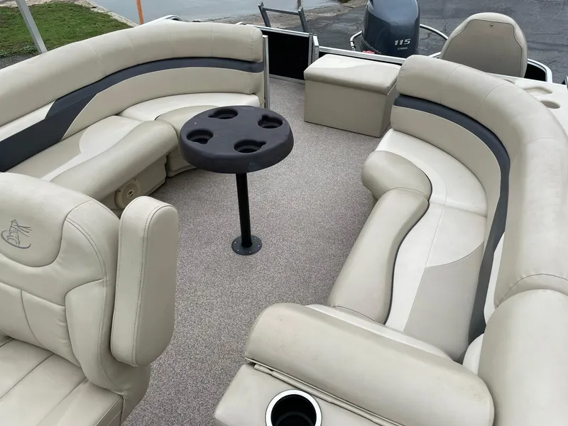 Slide: The Image of 2017 Misty Harbor 245 Adventure CC boat interior with beige seating and round table. - 12
