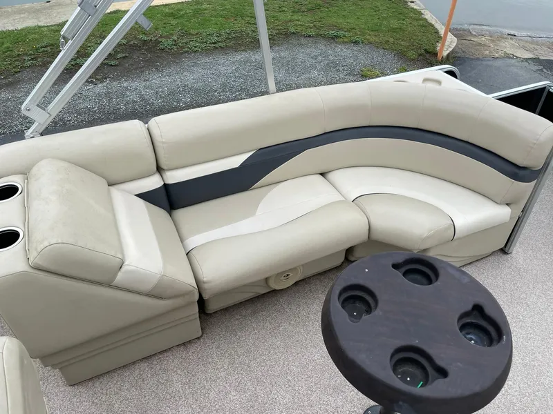 Slide: The Image of 2017 Misty Harbor 245 Adventure CC boat with beige seating and cup holders. - 14