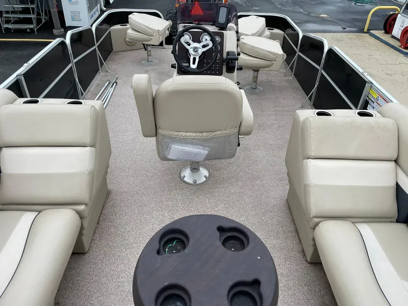 Slide: The Image of 2017 Misty Harbor 245 Adventure CC boat interior with beige seating and steering console. - 17